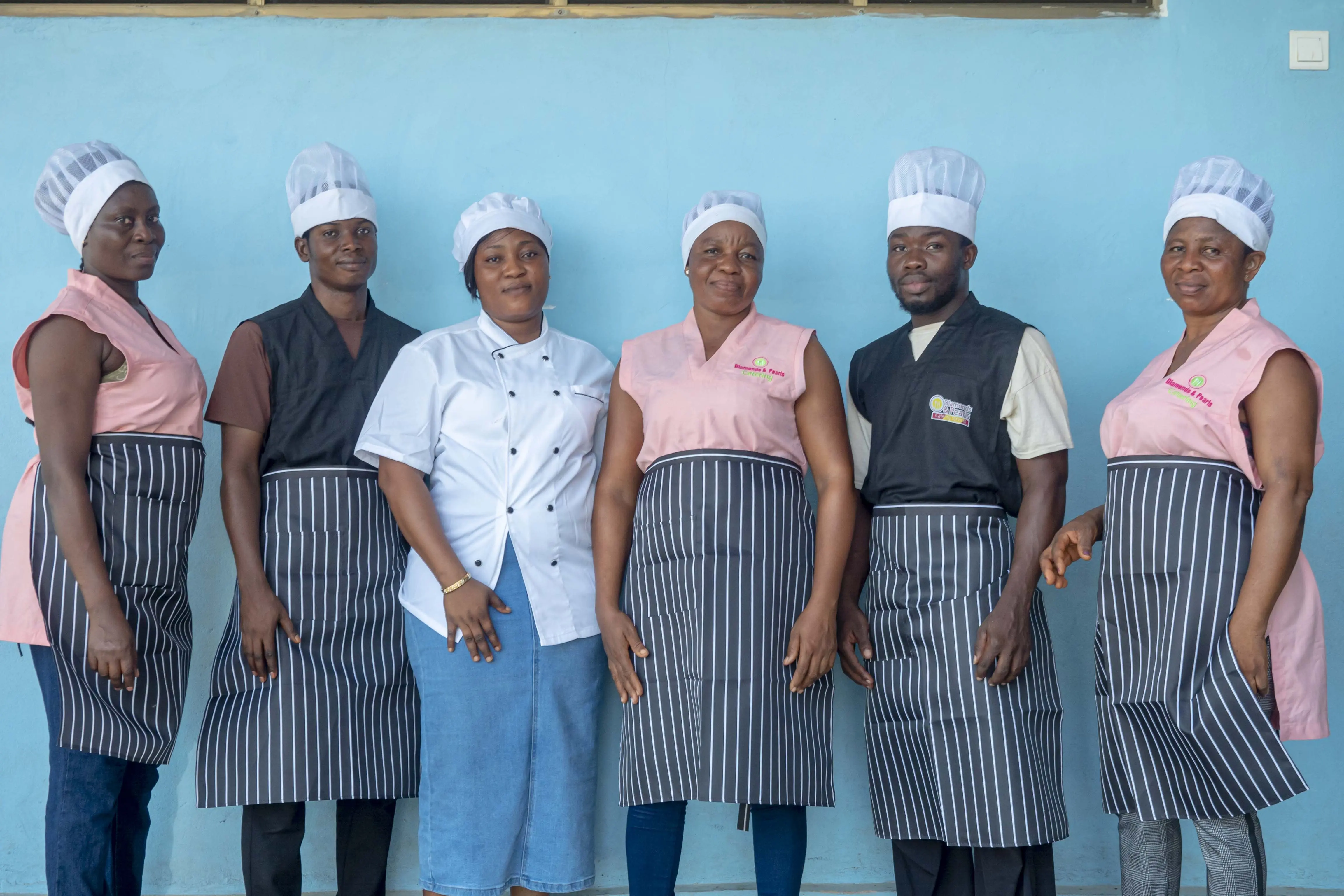The full Diamonds & Pearls Catering staff team in uniform, ready to serve at events across Accra, Ghana